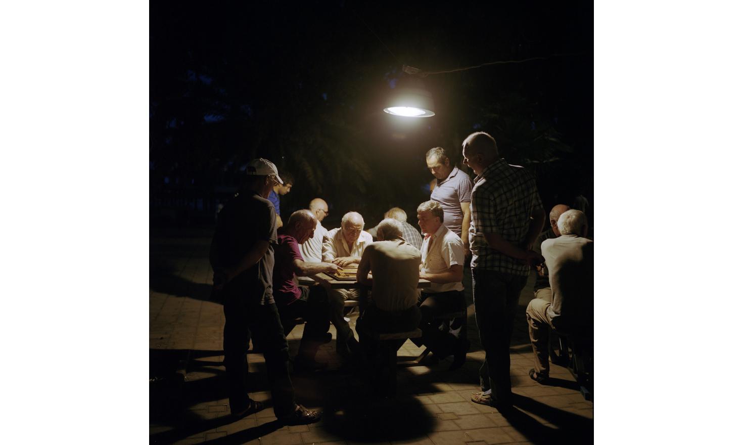 Evening in Sukhum(i). Men meet and play draughts, chess and backgammon in this little square.
