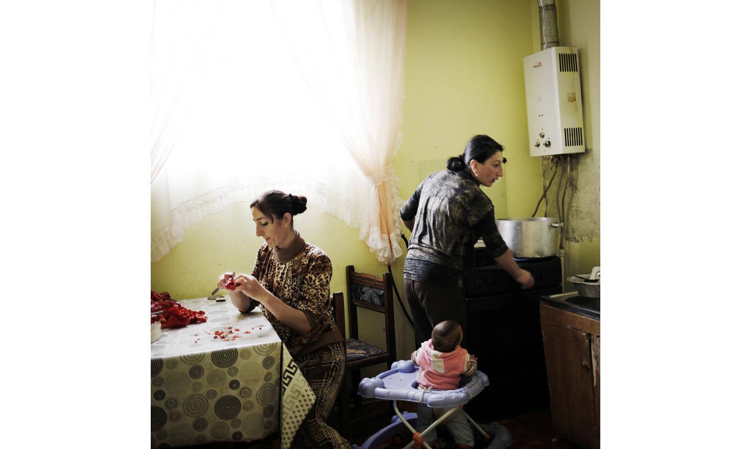This is the time to prepare cans. Several days of work will be needed to prepare the stock for the winter. Anoush is slicing peppers while Ruzanna cooks them. In the same time they are watching Naïre, Ruzanna's daugher.