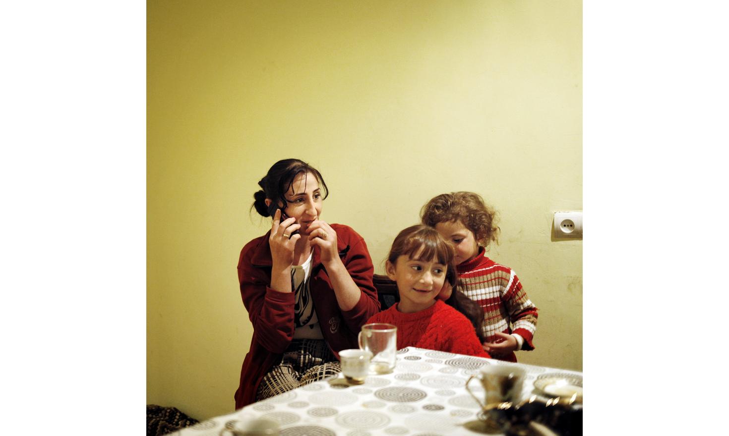 Anoush is calling her husband in Russia. On her the right are her two daughters, Lilith is doing Asmik's hair.