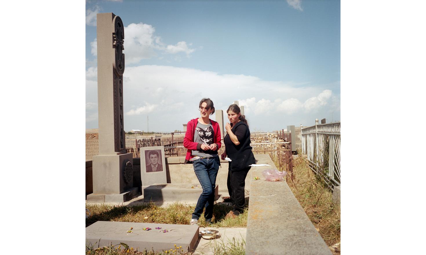 Today is the feast of the dead, the villagers go to the cemetery. They burn incense on the graves and will leave candy as offering. Ana (left) and Elvira (right) (cousins ââby marriage) go there together. Their husbands are in Russia.