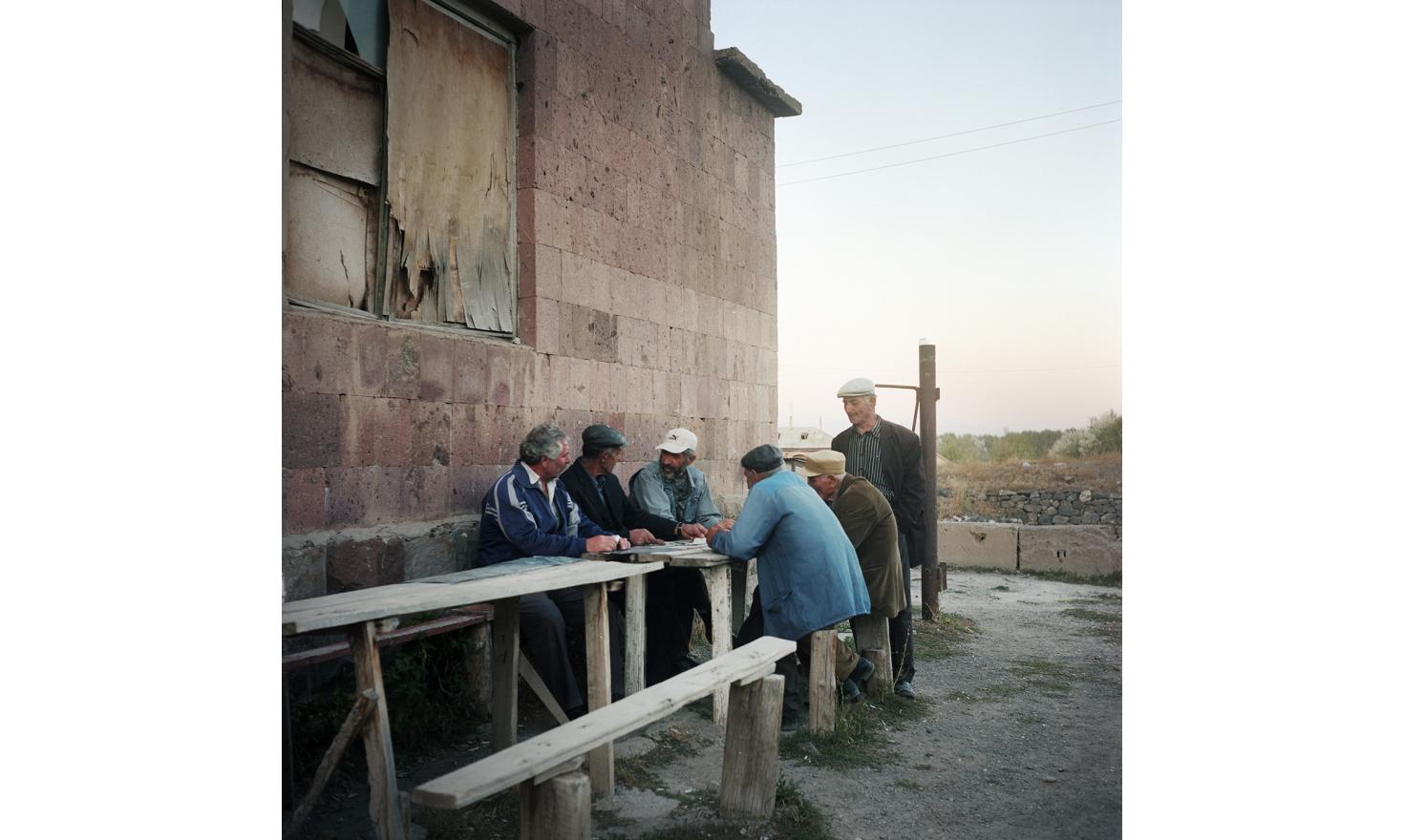 Every day they're here, it is the point of gathering for the old men of the village. They play cards, talk, play with their rosaries and tell how life has become difficult here.