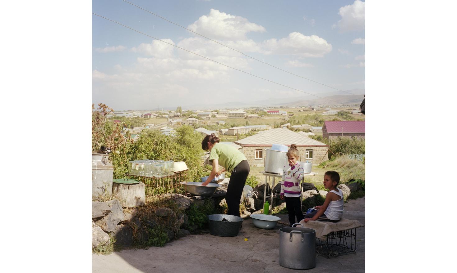 A villager just finished preparing cans for the winter. Her husband works in Russia too.