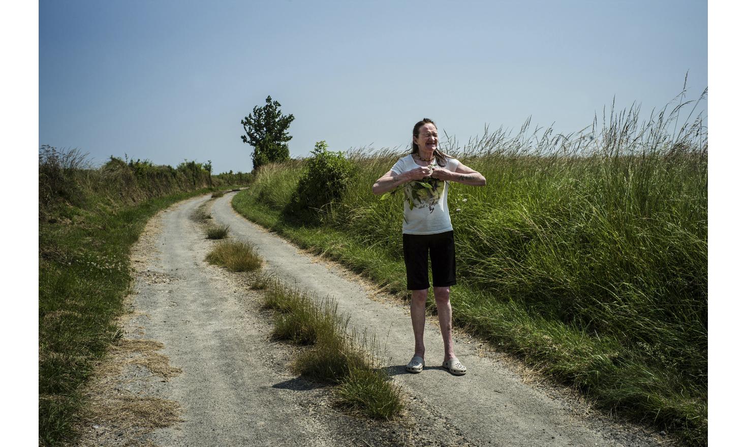 ©Ulrich Lebeuf / M.Y.O.P A summer walk around Berteaucourt-les-Dames. Isabelle's face is marked by suffering.